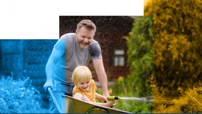 family plays with wheel barrow