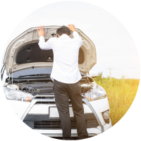 Man standing by broken down car